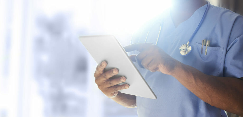 Nurse using tablet wearing scrubs