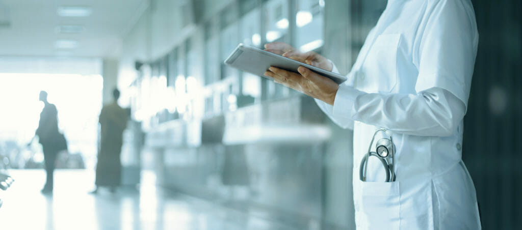 Doctor working on digital tablet in hospital