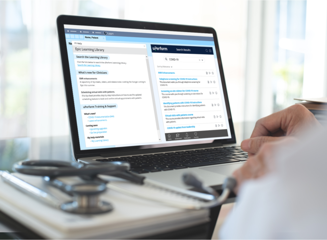Physician working on laptop with uPerform's Epic in-app training content accessible via F1 Help on screen