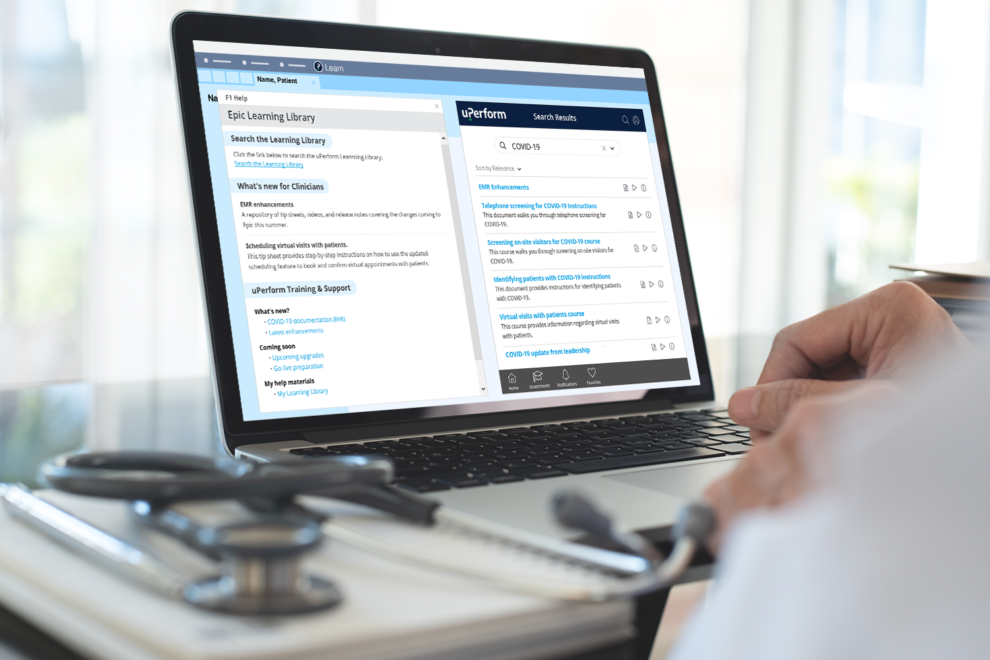 Physician working on laptop with uPerform's Epic in-app training
