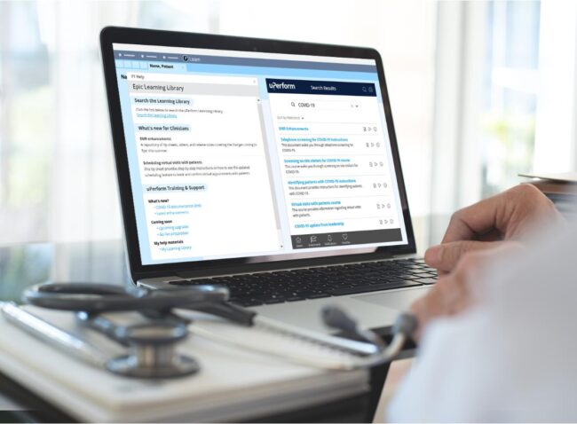 Physician working on laptop with uPerform's Epic in-app training