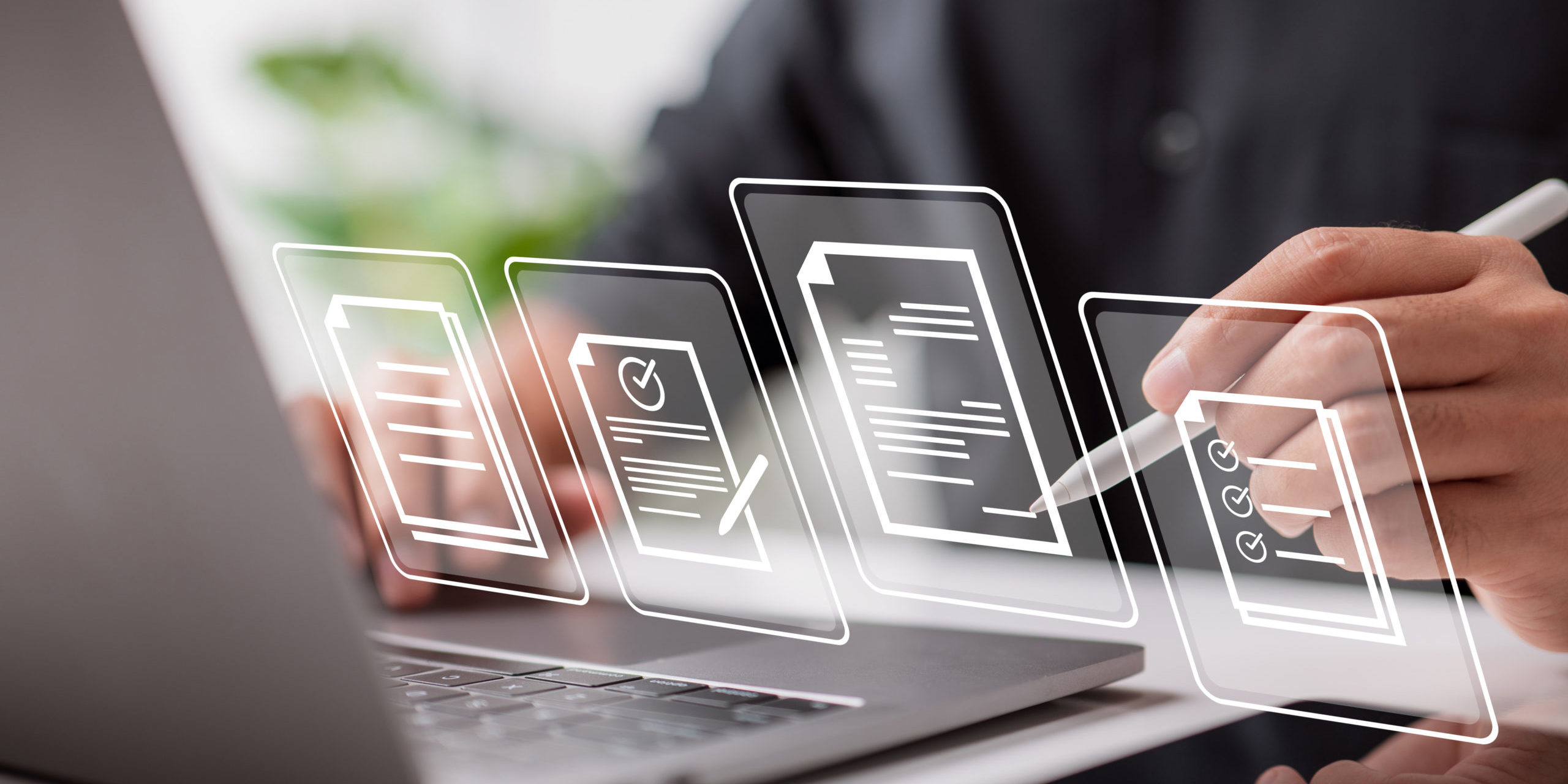 Man at laptop with 3D document icons representing scalability and centralization