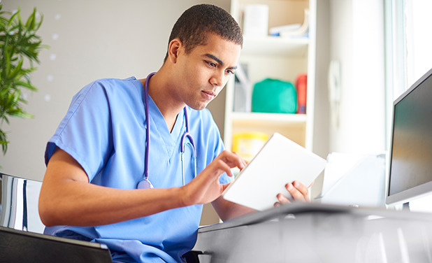 Young male nurse on table completing course