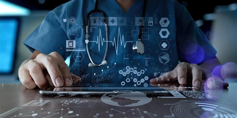 clinician wearing scrubs and stethoscope working on a high tech tablet