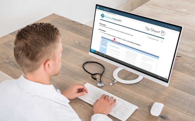 young male doctor accessing a tip sheet on a computer