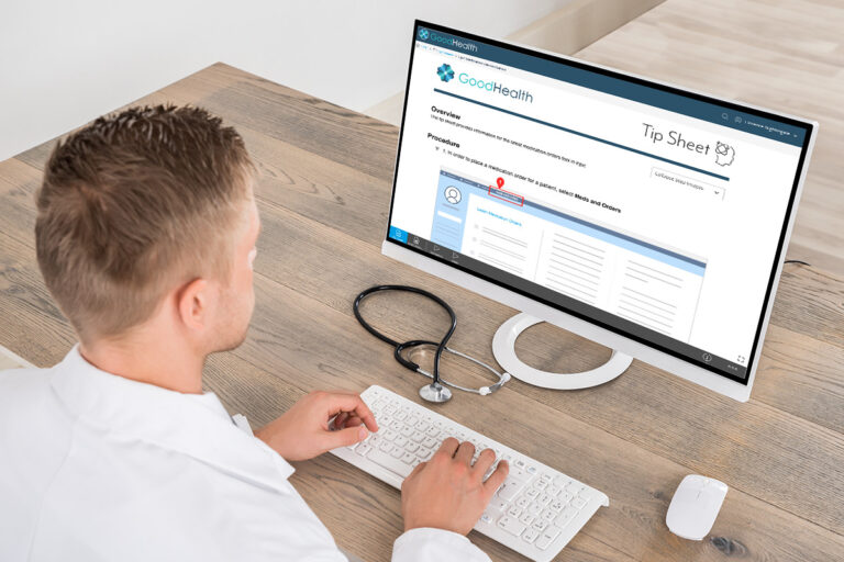 young male doctor accessing a tip sheet on a computer