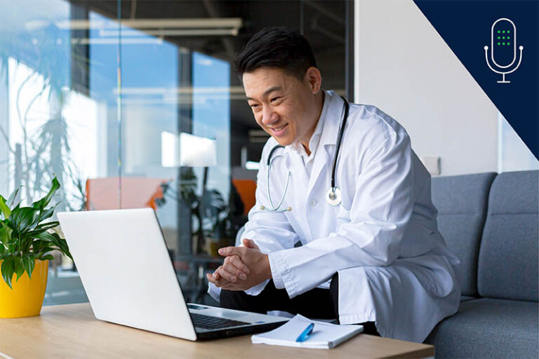 Doctor on laptop looking at course content with pen and paper