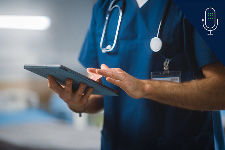 Close up of nurse, from shoulder to waist, using iPad while wearing scrubs and stethoscope