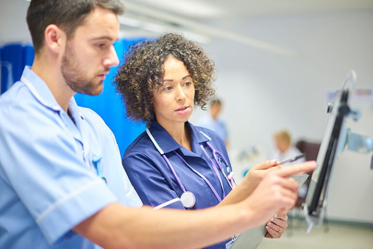 nurse helping another nurse navigate EPR