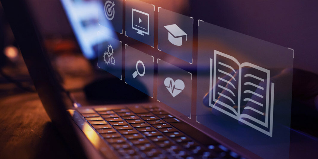 various digital icons - including a graudation cap, heart with a heart monitor line, search icon, and more - superimposed over laptop screen, representing virtual EHR training.