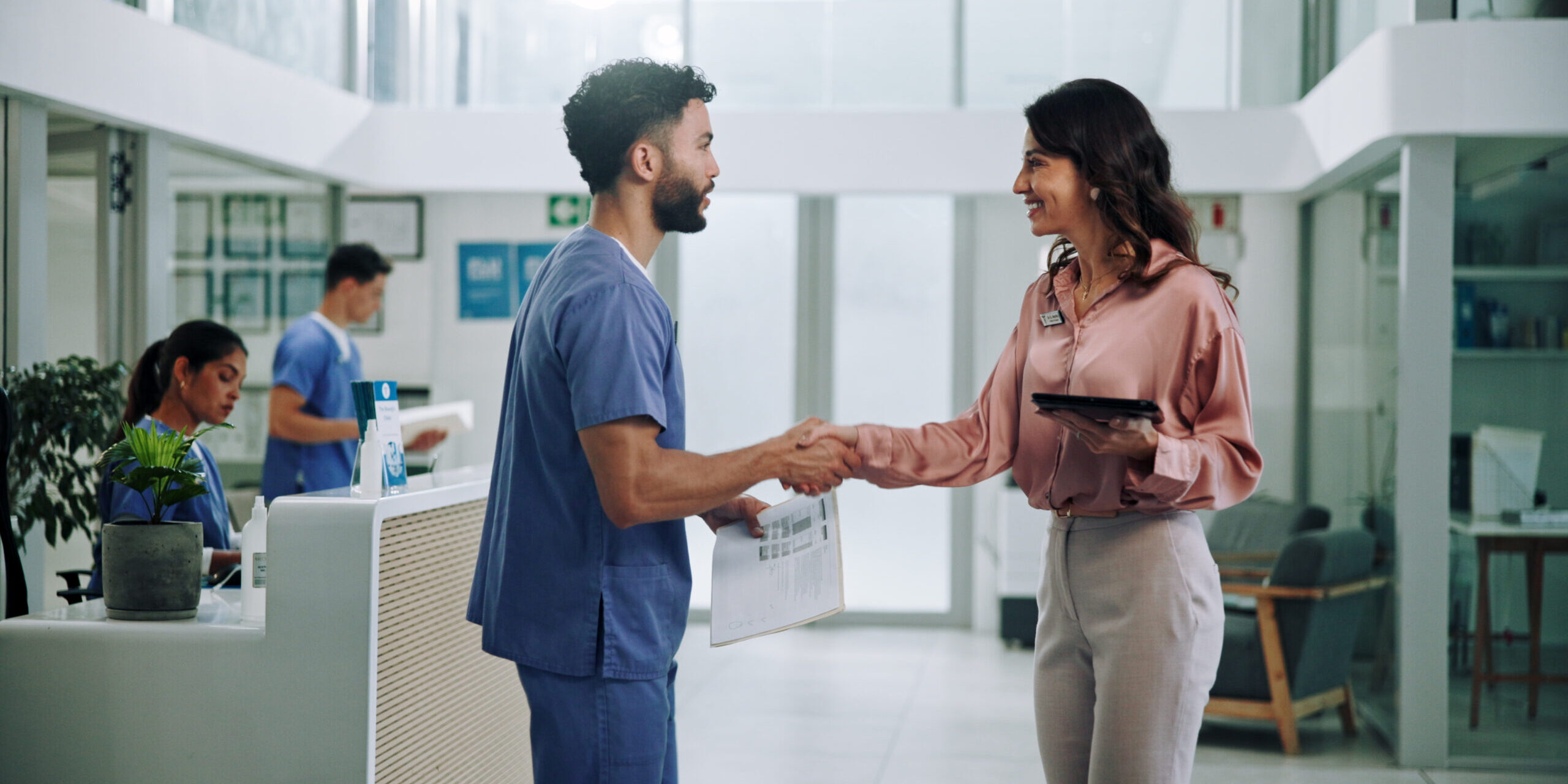 Doctor, meeting and tablet with handshake for hiring nurse at hospital. Medical colleagues shaking hands for recruitment together at hospital.