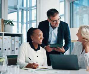Accounting, office and business people with meeting, feedback and manager for laptop, discussion and graphs. Training, teamwork and talk with tablet, growth strategy or project report for finance Accounting, office and business people with meeting, feedback and manager for laptop, discussion and graphs. Training, teamwork and talk with tablet, growth strategy or project report for finance